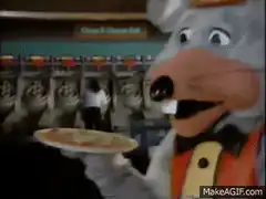 Chuck E. Cheese mascot serves pizza to kids
