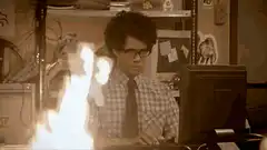 Mitchell typing while desk burns