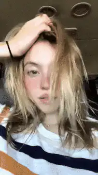 Girl fixing hair and sticking tongue out