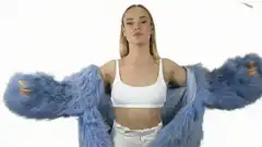 Woman in blue fur coat with money falling