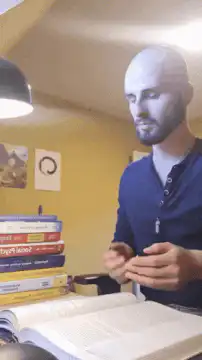 Bald man studying and gesturing