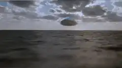 Blue iceberg floating over ocean