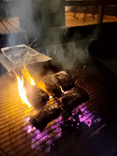 Flaming steaks on a grill