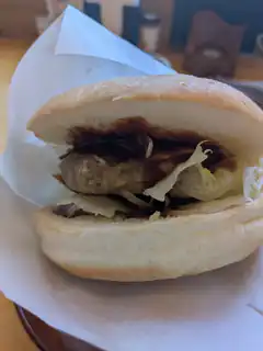 close-up of a burger with patty and lettuce