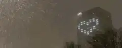 Heart lights on building in snow