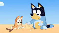 Bluey and Bingo building sandcastles