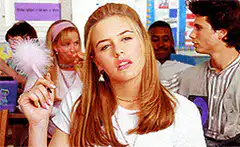 Regina George holding a pink feather duster
