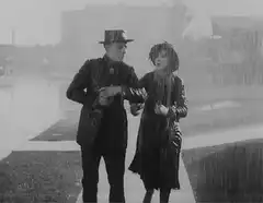Man and woman dancing in the rain
