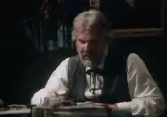 Old man pours drink at table