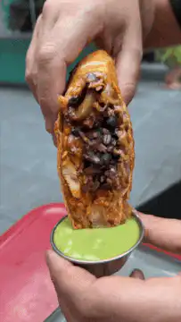 Burrito dipped in guacamole