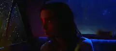 Woman in car with changing lights