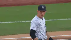 baseball player adjusting glove