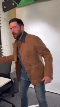 Man in brown jacket dancing