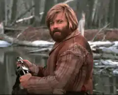 Dude holding a gun and smiling