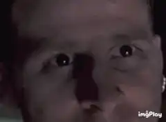 Man with wide eyes staring intensely