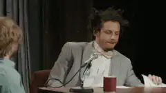 TJ Miller holds up RULES sign