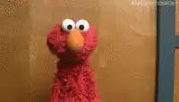 Elmo dancing and looking confused