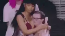 Woman hugging excited man with glasses