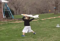 Boy throws model airplane
