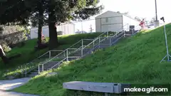 skateboarder grinds down long handrail