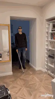 Man with cane and sunglasses dancing