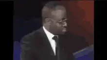 African man in suit turns head