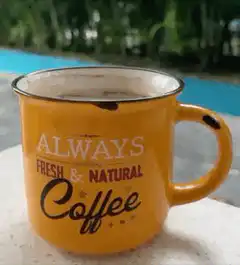 Orange coffee mug with text