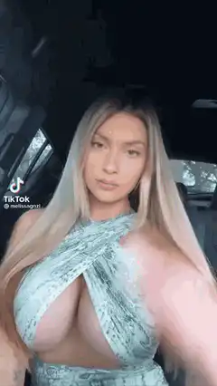 Woman in car posing in snakeskin outfit