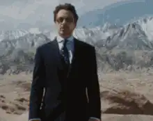Tony Stark stands in desert with arms out