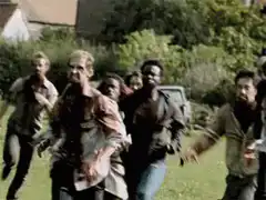 Zombies running across a lawn