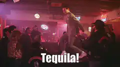 Man dancing on table in bar