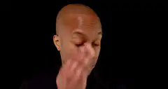 Man facepalms and peeks through fingers