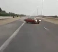 Red car drifting on highway