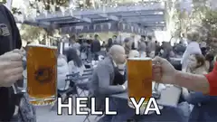 Two people clinking beer mugs saying hell ya
