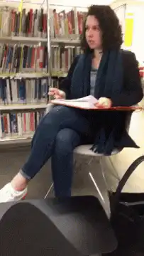 Woman in library looking confused