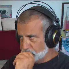 Man with headphones winking and smiling