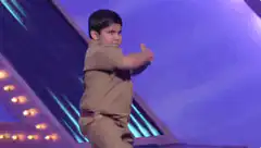 Young boy in uniform dancing on stage