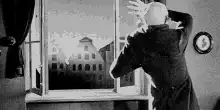 Old man looking out window
