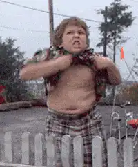 Boy struggling to put on shirt