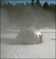 Snow-covered silo tipping over