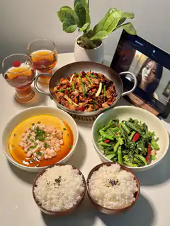 Chinese meal with tablet showing actress