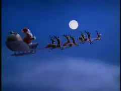 Santa Claus flying in sleigh with reindeer