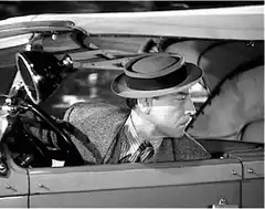 Man in car blows a kiss