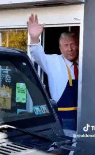 Donald Trump waving in apron