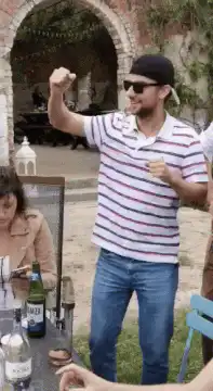 Man in striped shirt dancing outdoors