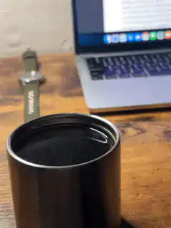coffee cup on desk with laptop