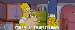 Homer holds pig, says you smiled I'm off the hook