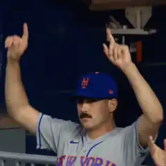 Baseball player pointing to sky