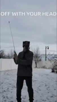 Man swings stick at own head