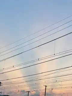 power lines against sunset sky